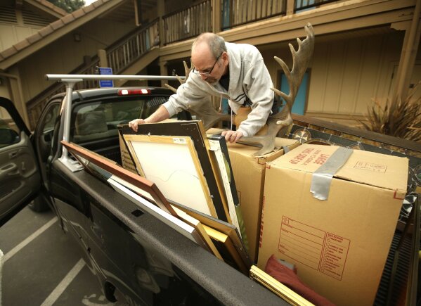 
              Neal O'Mara loads his pickup as he prepares to evacuate the town of Sonoma, Calif., Wednesday, Oct.11, 2017. With fires getting near, the town was placed under a voluntary evacuation order.(AP Photo/Rich Pedroncelli)
            