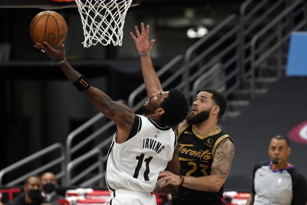 Brooklyn Nets guard Kyrie Irving (11) goes up for a shot in front of Toronto Raptors guard Fred VanVleet (23) during the second half of an NBA basketball game Tuesday, April 27, 2021, in Tampa, Fla. (AP Photo/Chris O'Meara)