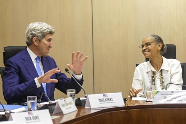 U.S. Special Presidential Envoy for Climate John Kerry, left, talks with Brazilian Environment Minister Marina Silva at the Environment Ministry in Brasilia, Brazil, Tuesday, Feb. 28, 2023. (AP Photo/Gustavo Moreno)
