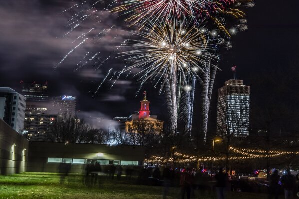 In this Dec. 31, 2019 photo,  fireworks explode over Bicentennial Mall during the Jack Daniel's Music City Midnight New Year's Eve celebration in Nashville, Tenn.  The Christmas morning bombing of the downtown tourist district forced organizers of what was already slated to be a very muted New Year’s celebration to dial it back even further. Nashville had already canceled its outdoor public concert for a televised one. But organizers had hoped to blow up a 2020 number and have fireworks as a way to say good riddance to a terrible year. (Alan Poizner/The Tennessean via AP)