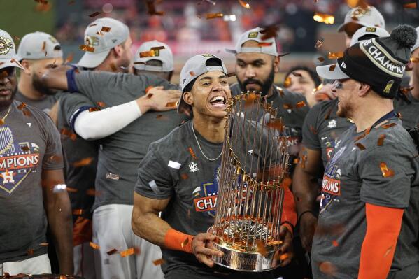 Houston Astros shortstop Jeremy Pena celebrates with the trophy after their 4-1 World Series win against the Philadelphia Phillies in Game 6 on Saturday, Nov. 5, 2022, in Houston. (AP Photo/David J. Phillip)