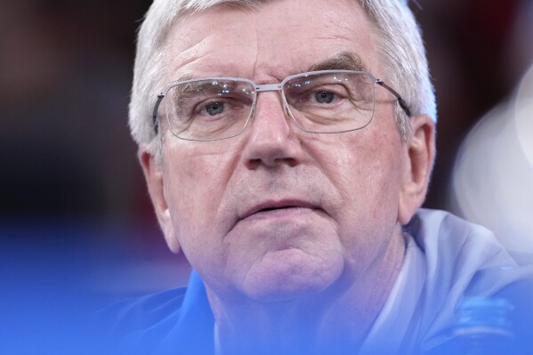 IOC President Thomas Bach attends at the men's men -81kg bronze medal match in team judo competition at Champ-de-Mars Arena during the 2024 Summer Olympics, Tuesday, July 30, 2024, in Paris, France. (AP Photo/Eugene Hoshiko)