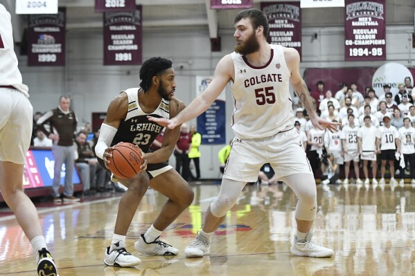 Lehigh forward Bube Momah (23) is defended by Colgate forward Jeff Woodward (55) during the first half of an NCAA college basketball game for the championship of the Patriot League tournament in Hamilton, N.Y., Wednesday, March 13, 2024. (AP Photo/Adrian Kraus)