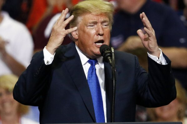 
              In this Oct. 2, 2018 photo, President Donald Trump gestures as he speaks at a rally in Southaven, Miss.   President Trump misrepresented the testimony of his Supreme Court nominee’s chief accuser on a rally stage over the past week as campaign politics and the pitched struggle over Brett Kavanaugh’s fate.  (AP Photo/Rogelio V. Solis)
            