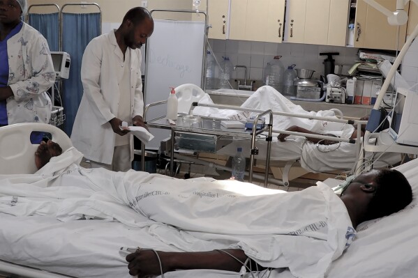 In this video frame grab, victims of a stamped lay in Brazzaville, Congo, hospital Tuesday, Nov. 21, 2023. A late night stampede at a military stadium where large crowds of young people waited hours to register at a recruitment event left dozens dead, authorities said on Tuesday. (AP Photo)