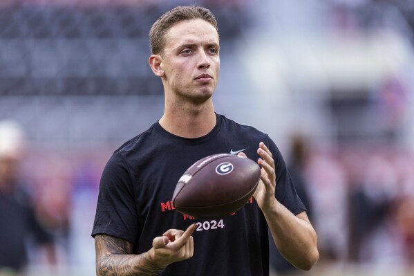 Then-Georgia quarterback Carson Beck (15) takes the field for early warm-ups before an NCAA college football game against Alabama, Saturday, Sept. 28, 2024, in Tuscaloosa, Ala. (AP Photo/Vasha Hunt, File)