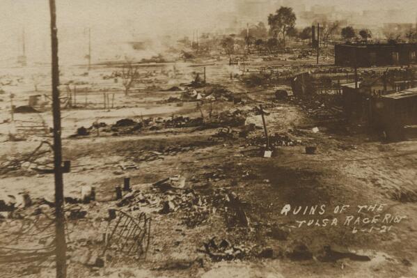 This photo provided by the Department of Special Collections, McFarlin Library, The University of Tulsa shows the ruins of Dunbar Elementary School and the Masonic Hall in the aftermath of the June 1, 1921, Tulsa Race Massacre in Tulsa, Okla. (Department of Special Collections, McFarlin Library, The University of Tulsa via AP)