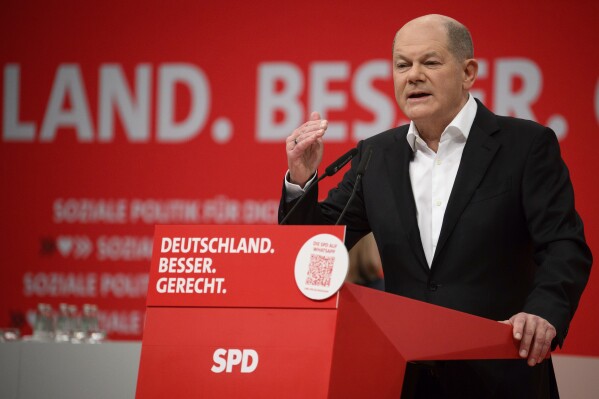 German Chancellor Olaf Scholz speaks at the SPD's regular federal party conference at the Berlin Exhibition Center, Berlin, Saturday Dec. 9, 2023. (Bernd von Jutrczenka/dpa via AP)