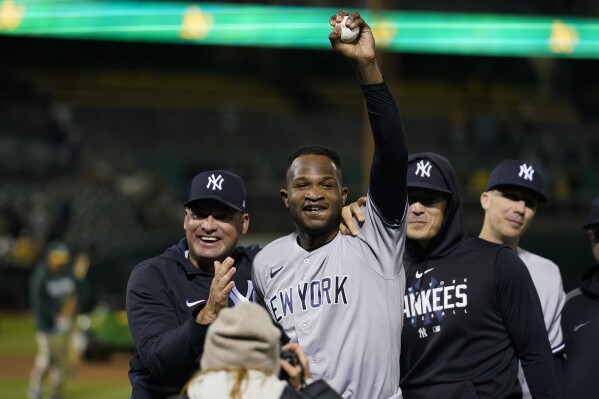 New York Yankees' Domingo Germán, center, celebrates after pitching a perfect game against the Oakland Athletics during a baseball game in Oakland, Calif., Wednesday, June 28, 2023. The Yankees won 11-0. (AP Photo/Godofredo A. Vásquez)