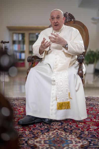 Pope Francis speaks during an interview with The Associated Press at The Vatican, Tuesday, Jan. 24, 2023. According to the pope, the arms industry has brought untold death and destruction to the world. “The world is obsessed with weapons,” he said. (AP Photo/Domenico Stinellis)