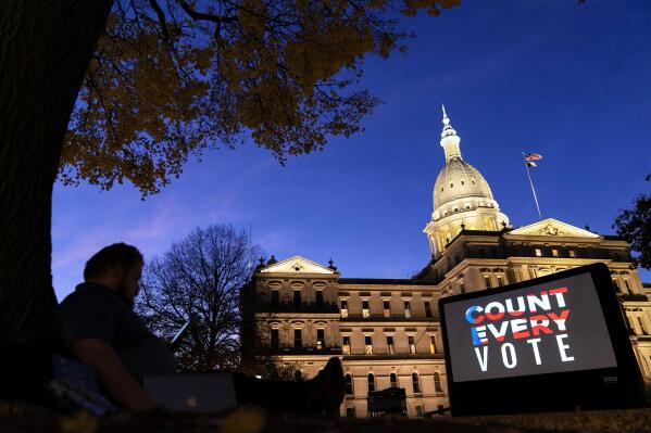 FILE - The phrase "Count Every Vote" is displayed on a large screen, organized by an advocacy group in front of the State Capitol on Nov. 6, 2020, in Lansing, Mich. As local election offices across the U.S. count millions of votes on election night, Nov. 8, 2022, they share the results with polling firms, which transmit them to viewers watching live on their devices. Along the way, humans reporting these results occasionally make errors, causing false vote counts to temporarily appear in TV news graphics. However, these small mistakes are not a sign of anything nefarious — and fortunately, quality control measures in election offices and polling firms ensure they happen rarely and get fixed quickly. (AP Photo/David Goldman, File)