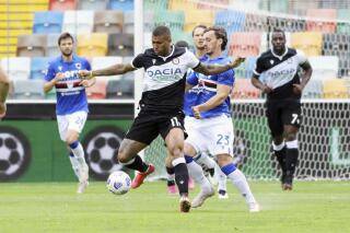 Udinese's Walance Souza vies for the ball with Sampdoria's Manolo Gabbiadini, during the Italian Serie A soccer match between Udinese and Sampdoria, at the Dacia Arena stadium in Udine, Italy, Sunday, May 16, 2021. (Andrea Bressanutti/LaPresse via AP)