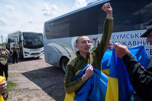 A Ukrainian soldier shouts, "Glory to Ukraine," after returning from captivity in Russia, in the Sumy region of Ukraine, May 31, 2024. (AP Photo/Evgeniy Maloletka)