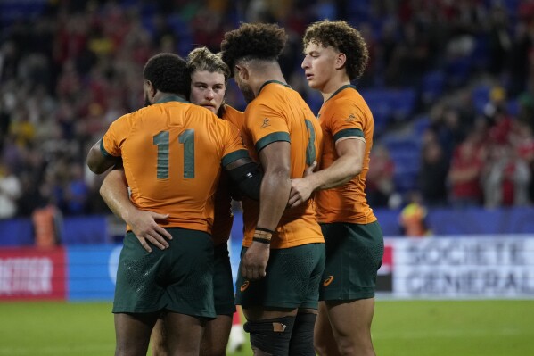 Australia's Marika Koroibete, Fraser McReight, Rob Valetini and Mark Nawaqanitawase react after the Rugby World Cup Pool C match between Wales and Australia at the OL Stadium in Lyon, France, Sunday, Sept. 24, 2023. Wales won the match 40-6. (AP Photo/Christophe Ena)