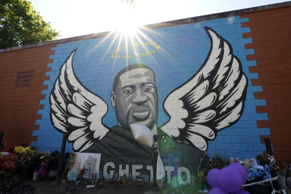 In this Sunday, June 7, 2020, photo, the sun shines above a mural honoring George Floyd in Houston’s Third Ward. Floyd, who grew up in the Third Ward, died after being restrained by Minneapolis police officers on Memorial Day. (AP Photo/David J. Phillip)