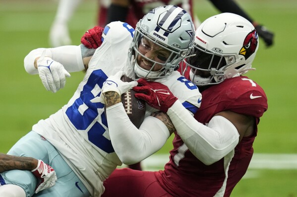 Dallas Cowboys tight end Peyton Hendershot (89) is hit by Arizona Cardinals linebacker Kyzir White (7) during the first half of an NFL football game, Sunday, Sept. 24, 2023, in Glendale, Ariz. (AP Photo/Ross D. Franklin)