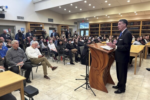 Rep. David Kustoff, R-Tenn., right, speaks with people at Margolin Hebrew Academy-Feinstone Yeshiva of the South on Monday, Oct. 30, 2023, in Memphis, Tenn. Kustoff and Tennessee Gov. Bill Lee are praising security measures at the school where an ex-student with a gun was stopped from entering the building in July. (AP Photo/Adrian Sainz).