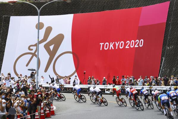 Cyclists compete in the men's cycling road race at the 2020 Summer Olympics, Saturday, July 24, 2021, in Oyama, Japan. (Tim de Waele/Pool Photo via AP)