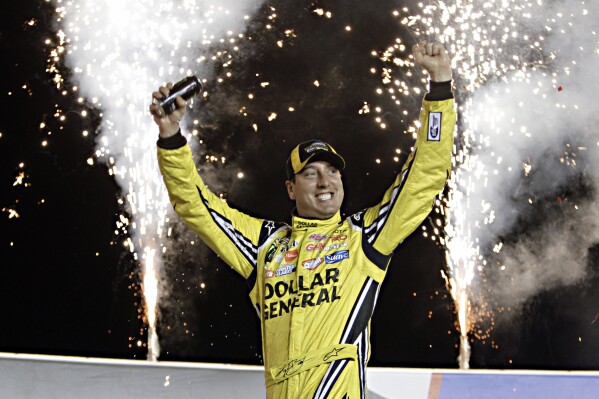 Kyle Busch celebrates in Victory Circle after winning the NASCAR Trucks auto race at Kentucky Speedway in Sparta, Ky., June 26, 2014. (AP Photo/Garry Jones, file)