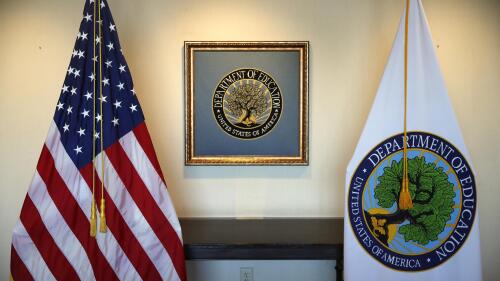 FILE - Flags decorate a space outside the office of the education secretary at the Education Department, Aug. 9, 2017, in Washington. College programs that leave graduates underpaid or buried in loans would be cut off from federal money under a proposal issued Wednesday, May 17, 2023, by the Biden administration, but the rules would apply only to for-profit colleges and a tiny fraction of programs at traditional universities. (AP Photo/Jacquelyn Martin, File)