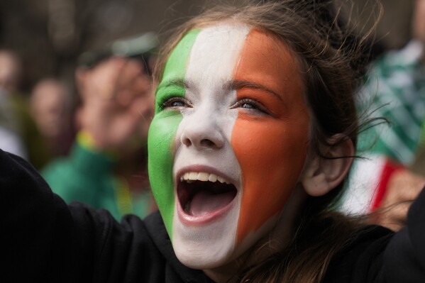 Ava Impell, 11, of Pittsburgh watches the St. Patrick's Day parade in Chicago on Saturday, March 16, 2024. (AP Photo/Erin Hooley)