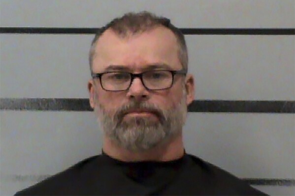 This image provided by the Lubbock County Detention Center shows Frederick Francis Goltz, 52, of Lubbock, Texas. Goltz, who advocated for a mass shooting of poll workers and threatened two Arizona officials and their children, has been sentenced to 3 1/2 years in federal prison, prosecutors said Friday, Aug. 4, 2023. (Lubbock County Detention Center via AP)