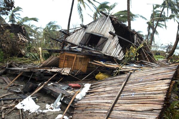 A house lays in ruins in Mananjary, Madagascar, Thursday, Feb. 10, 2022. The toll of Cyclone Batsirai in Madagascar has risen to 92 deaths and more than 112,000 people displaced by the tropical storm which rampaged across the island earlier this week, the national disaster management office announced Wednesday.  (AP Photo/Viviene Rakotoarivony)