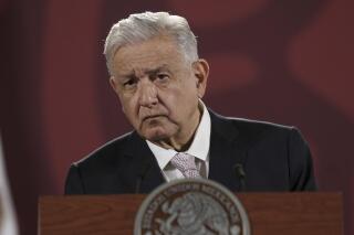 FILE - Mexican President Andres Manuel Lopez Obrador listens to a journalist's question during his daily press conference at the National Palace in Mexico City, July 8, 2022. In a bid to stoke nationalism and justify his policies, Mexico’s president has increasingly taken to calling his opponents “traitors” and accused them of working for the foreign governments.  (AP Photo/Moises Castillo, File)