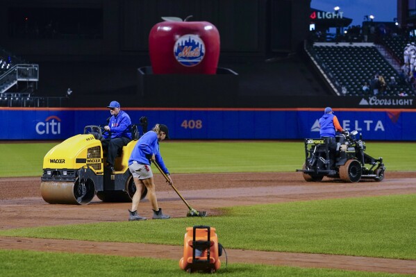 Ground crews work on the field before a baseball game between the Miami Marlins and the New York Mets, Tuesday, Sept. 26, 2023, at Citi Field in New York. (AP Photo/Frank Franklin II)