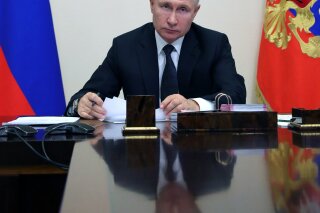 Russian President Vladimir Putin attends a meeting via video conference in Moscow, Russia, Wednesday, Dec. 23, 2020. (Mikhail Klimentyev, Sputnik, Kremlin Pool Photo via AP)