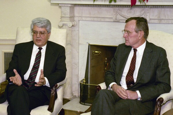 FILE - Israeli Foreign Minister David Levy, left, gestures while meeting with President George H. W. Bush in the Oval Office to discuss the progress of Middle East peace talks, Dec. 17, 1991, in Washington. Levy, an Israeli politician born in Morocco who fought tirelessly against deep-seated racism against Jews from North Africa and went on to serve as foreign minister and hold other senior governmental posts, died Sunday, June 2, 2024. He was 86. (AP Photo/Ron Edmonds, File)