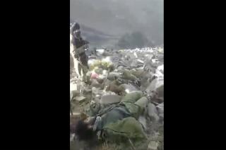 In this frame grab from video that was likely taken by the Taliban and posted online and provided by Afghan Witness, a UK-based open-source nonprofit, a Taliban fighter stands amid bodies on the ground, in the Dara district, of Panjshir province, Afghanistan, Sept. 14, 2022. The Taliban captured, bound and shot to death 27 men in Afghanistan’s Panjshir Valley last month during an offensive against resistance fighters in the area, according to a new report by Afghan Witness published Tuesday, Oct. 18, 2022 refuting the group’s earlier claims that the men were killed in battle. (Afghan Witness via AP)