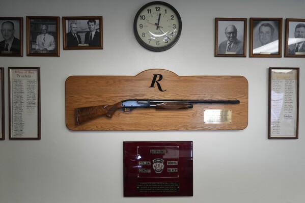 A shotgun made by Remington Arms, gifted by the company to the town, hangs on the wall of the municipal building in Ilion, N.Y., Thursday, Feb. 1, 2024. The nation鈥檚 oldest gun-maker is consolidating operations in Georgia and recently announced plans to shutter the Ilion factory in early March. (AP Photo/Seth Wenig)