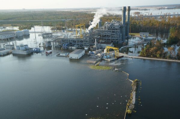 
              In this Sept. 21, 2018, photo released by Duke Energy, the L.V. Sutton Plant near Wilmington, N.C., is inundated by flood waters from the nearby Cape Fear River, triggering a shutdown and the evacuation of employees. Floodwaters also breached a dam at the electricity generating plant on Friday and overtopped a coal ash dump, potentially spilling toxic materials into the river. (Duke Energy via AP)
            