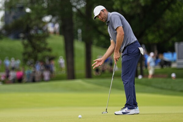 Scottie Scheffler reacts after missing a putt on the 10th hole during the second round of the PGA Championship golf tournament at the Quail Hollow Club, Friday, May 16, 2025, in Charlotte, N.C. (AP Photo/George Walker IV)