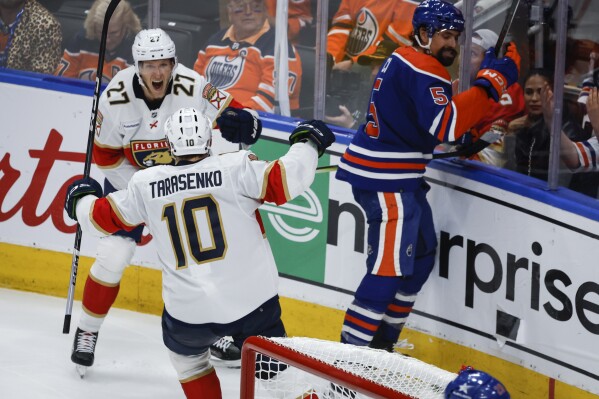 Florida Panthers' Vladimir Tarasenko (10) celebrates his goal with teammate Eetu Luostarinen (27) as Edmonton Oilers' Cody Ceci (5) reacts during the second period in Game 3 of the NHL hockey Stanley Cup Finals, Thursday, June 13, 2024, in Edmonton, Alberta. (Jeff McIntosh/The Canadian Press)