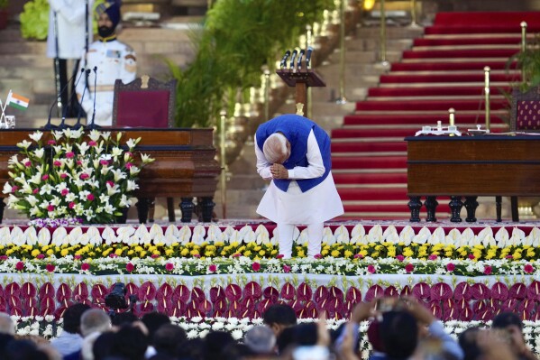 Narendra Modi greets the gathering as he arrives to take oath as the Prime Minister of India at the Rashtrapati Bhawan, in New Delhi, India, Sunday, June 9, 2024. The 73-year-old leader is only the second Indian prime minister to retain power for a third term. (AP Photo/Manish Swarup)