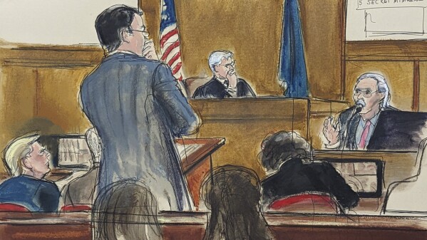 Former President Donald Trump, left, watches as David Pecker answers questions on the witness stand, far right, from assistant district attorney Joshua Steingless, in Manhattan criminal court, April 23, 2024, in New York. Testimony by the former National Enquirer publisher at Donald Trump's hush money trial this week has revealed an astonishing level of corruption at America's best-known tabloid and may one day be seen as the moment it effectively died. On Thursday, April 25, 2024 Pecker was back on the witness stand to tell more about the arrangement he made to boost Trump's presidential candidacy in 2016, tear down his rivals and silence any revelations that may have damaged him. (Elizabeth Williams via AP)