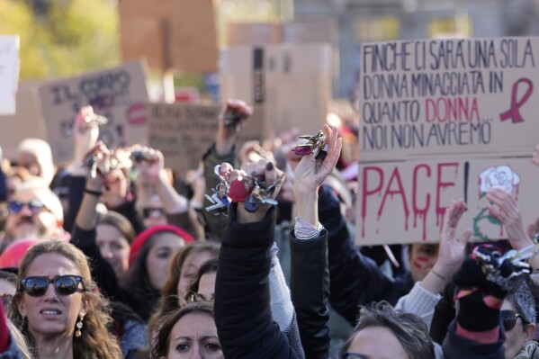Women show banners and keys during a demonstration on the occasion of International Day for the Elimination of Violence against Women, in Milan, Italy, Saturday, Nov.25, 2023. Thousands of people are expected to take the streets in Rome and other major Italian cities as part of what organizers call a "revolution" under way in Italians' approach to violence against women, a few days after the horrifying killing of a college student allegedly by her resentful ex-boyfriend sparked an outcry over the country's "patriarchal" culture. (AP Photo/Luca Bruno)