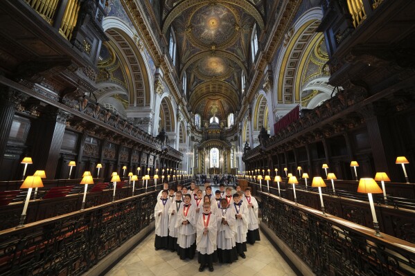 The Choristers of St Paul's choir, including girls for first time in 900-year history, rehearse for the Christmas services in St Paul's Cathedral, in London, Monday, Dec. 23 2024. (AP Photo/Kin Cheung)