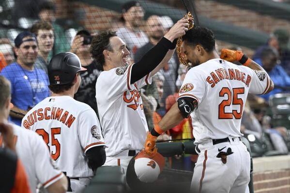 Baltimore Orioles' Austin Hays places the home run chain on Anthony Santander, who had hit a home run against the Washington Nationals during the third inning of a baseball game Wednesday, June 22, 2022, in Baltimore.(AP Photo/Gail Burton)