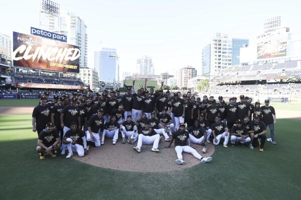 The San Diego Padres pose for a team photo following a baseball game against the Chicago White Sox after clinching a wild-card playoff spot Sunday, Oct. 2, 2022, in San Diego. (AP Photo/Derrick Tuskan)