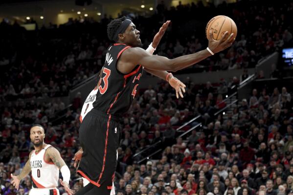 Toronto Raptors forward Pascal Siakam drives to the basket past Portland Trail Blazers forward Jerami Grant, obscure, during the first half of an NBA basketball game in Portland, Ore., Saturday, Jan. 28, 2023. (AP Photo/Steve Dykes)
