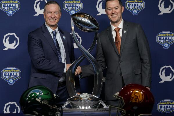 Tulane head coach Willie Fritz, left, and Southern California head coach Lincoln Riley pose for a photo during a press conference ahead of the Cotton Bowl NCAA college football game, Sunday, Jan. 1, 2023, in Dallas, Texas. Tulane will face Southern California in the Cotton Bowl on Monday, Jan. 2. (AP Photo/Sam Hodde)
