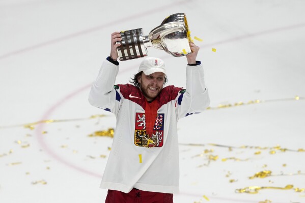 Czech Republic's David Pastrnak celebrates with their trophy after they defeated Switzerland 2-0 in a gold medal match at the Ice Hockey World Championships in Prague, Czech Republic, Sunday, May 26, 2024. (AP Photo/Darko Vojinovic)