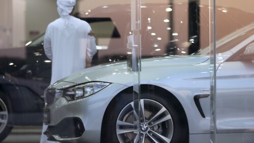 FILE - A man visits a car showroom in Dubai, United Arab Emirates, Thursday, June 2, 2016. A popular online influencer has been arrested in Dubai over a satirical TikTok video in which he portrays a brash Emirati on a spending spree inside a luxury car showroom. (AP Photo/Kamran Jebreili, File)