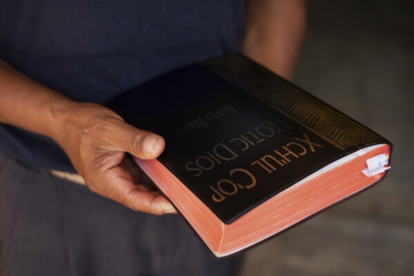 Deacon Juan Pérez Gómez holds a Bible translated into Tsotsil, a Mayan language, in the Simojovel municipality, Mexico, Saturday, April 26, 2025. (AP Photo/Isabel Mateos)