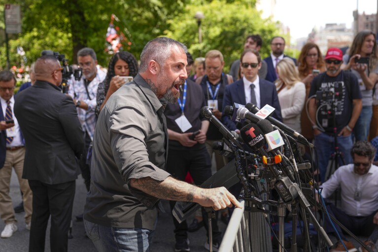 Former Washington, D.C. police officer Michael Fanone speaks to reporters in support of President Joe Biden across the street from former President Donald Trump's criminal trial in New York, Tuesday, May 28, 2024. (AP Photo/Seth Wenig)