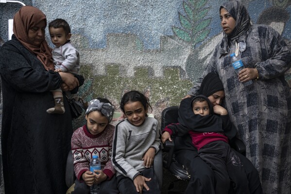 Palestinians mourn their relatives killed in the Israeli bombardment of the Gaza Strip, at the hospital Rafah, southern Gaza, Thursday, Dec. 21, 2023. (AP Photo/Fatima Shbair)