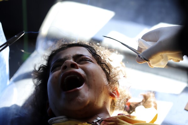 Palestinian doctors treat a girl who was injured in the Israeli bombing of the Gaza Strip at the Kuwaiti hospital in the Rafah refugee camp, southern Gaza, Tuesday, May 7, 2024. (AP Photo/Ramez Habboub)